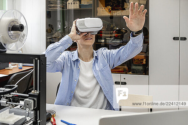 Student using 3D printer and VR goggles