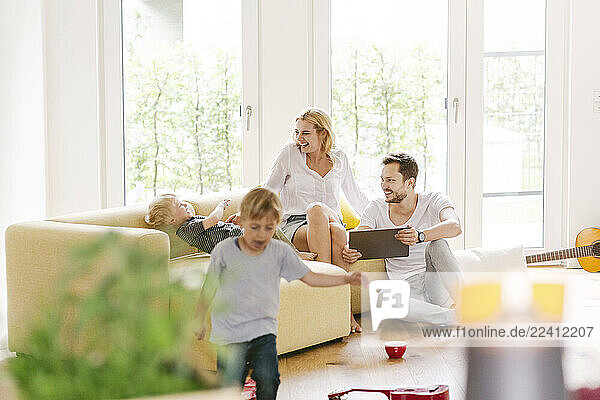 Happy family with two sons in living room of their new home