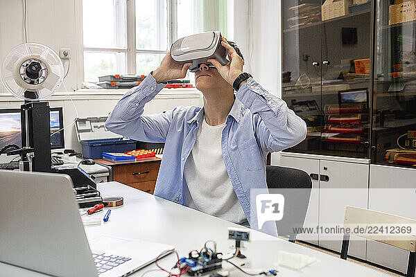Student using 3D printer and VR goggles