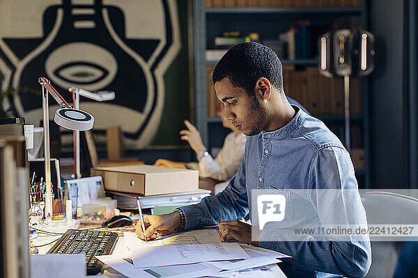 Young man working in architect s office