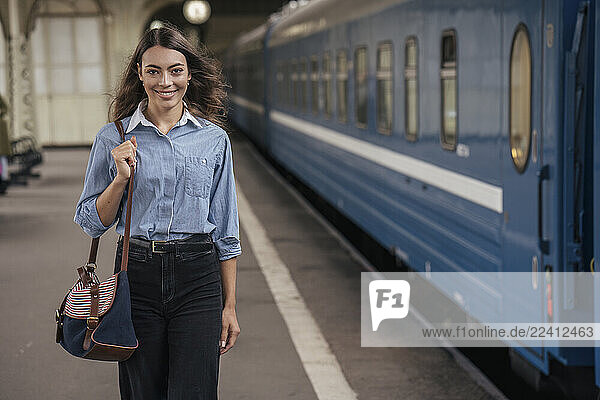 Young female traveller walking on the platform