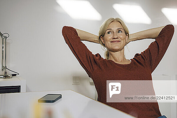 Woman relaxing at her desk in an office setting