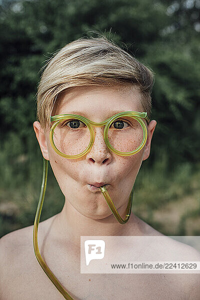 Portrait of freckled boy with funny glasses