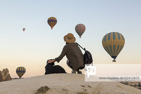 Young woman and hot air ballons  Goreme  Cappadocia  Turkey
