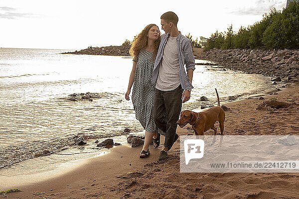 Young couple with dog at the beach