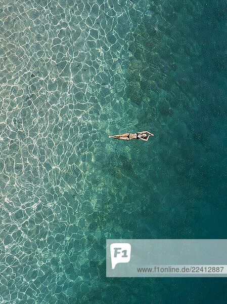 Woman floating in the sea  Gili Air  Gili Islands  Indonesia