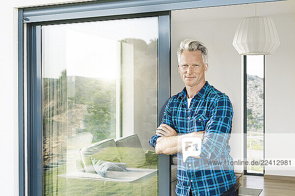 Portrait of confident man in his modern home