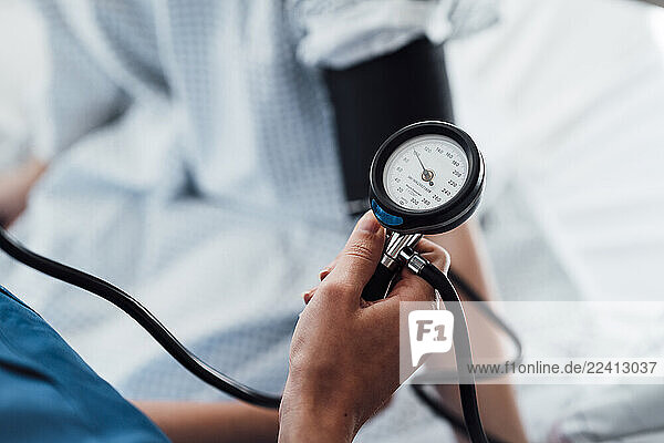 Doctor measuring blood pressure in a clinic setting