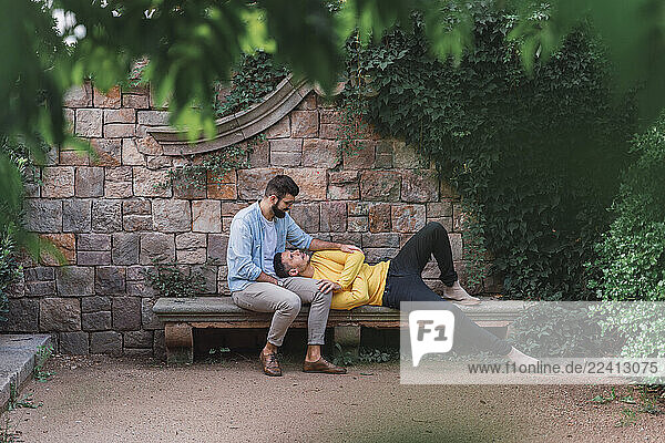 Gay couple relaxing together on a bench