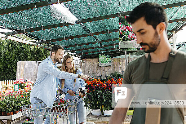 Couple buying flowers in a garden center