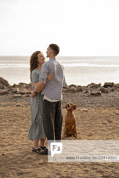 Young couple with dog at the beach