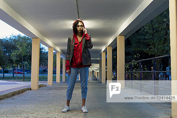 Portrait of young woman on the phone in the evening