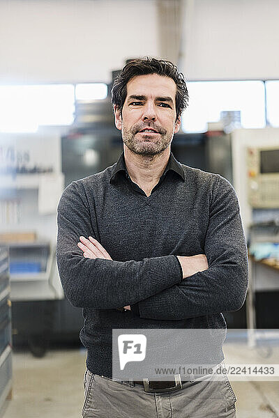 Portrait of a confident businessman in a factory