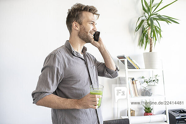 Smiling man on the phone in office