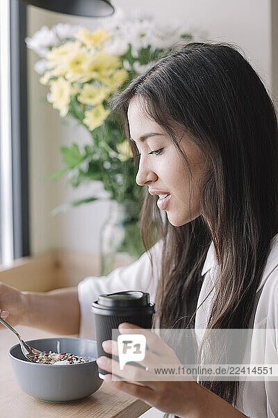 Young woman having breakfast in a cafe