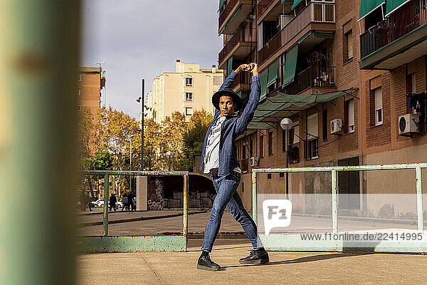 Young man moving and dancing outdoors