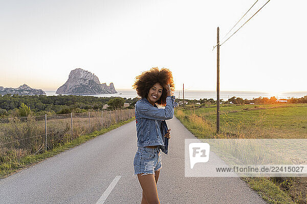 Young woman standing on street at sunset  Ibiza