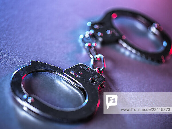 Close-up of metal handcuffs symbolizing justice and crime control