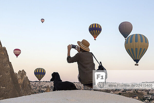 Young woman and hot air ballons  Goreme  Cappadocia  Turkey