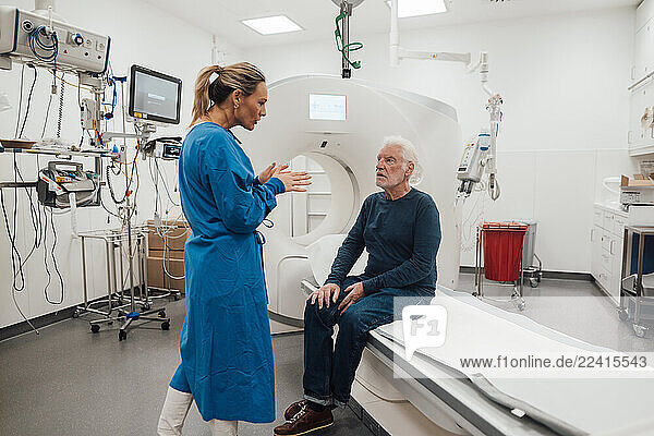 Doctor consulting with patient in a medical room with MRI machine