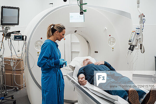 Doctor consulting patient during MRI scan in a clinic