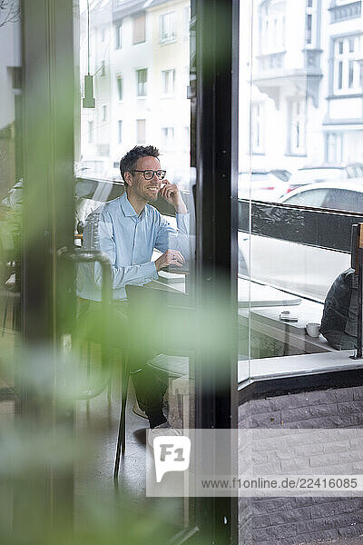 Businessman working remotely in a café with a tablet
