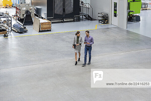 Business meeting in an industrial production hall