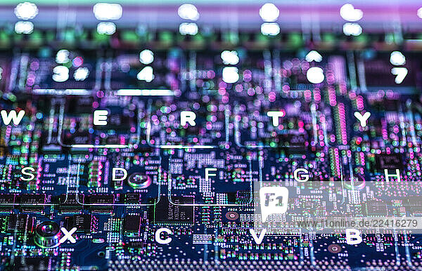 Close-up of a circuit board with glowing keyboard letters representing technology and artificial intelligence