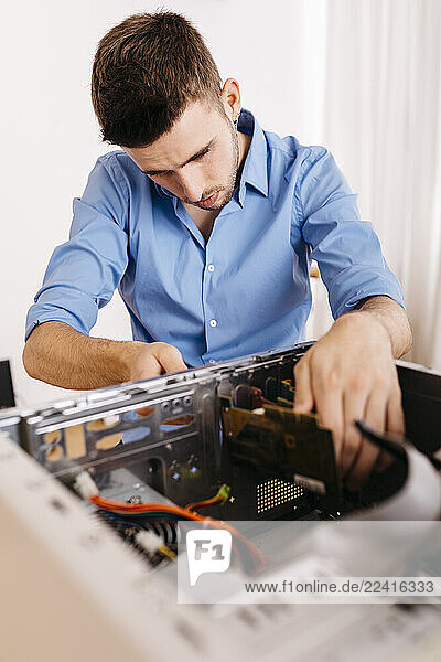 Technician repairing a desktop computer  changing circuit board