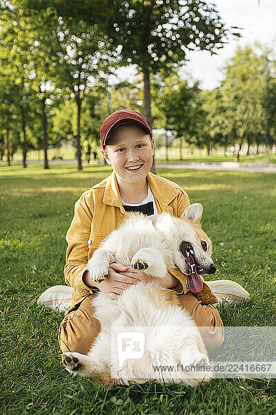 Boy with Welsh Corgi Pembroke in a park