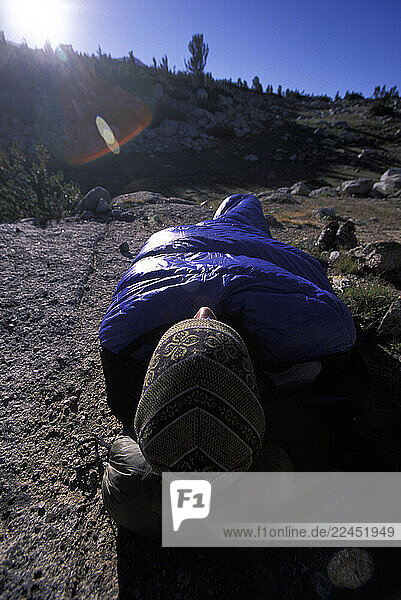Man in his sleeping bag in Eastern Sierra Nevada mountains  California.