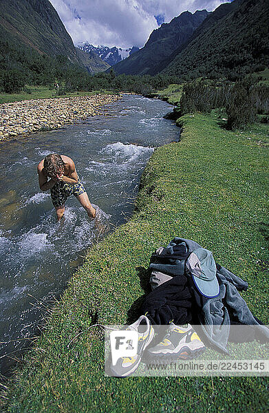 A man washes up in a mountain stream.