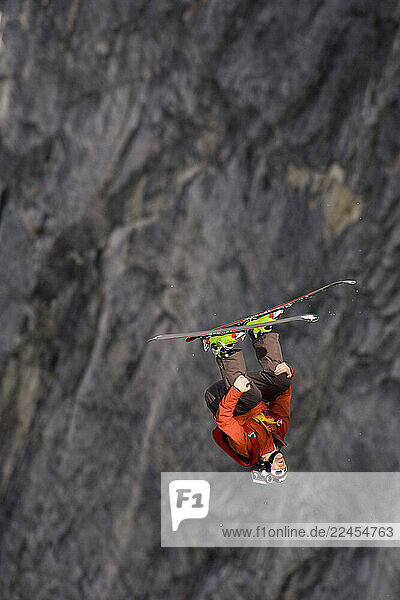 A male Ski BASE jumper jumps off an 800 foot granite cliff.