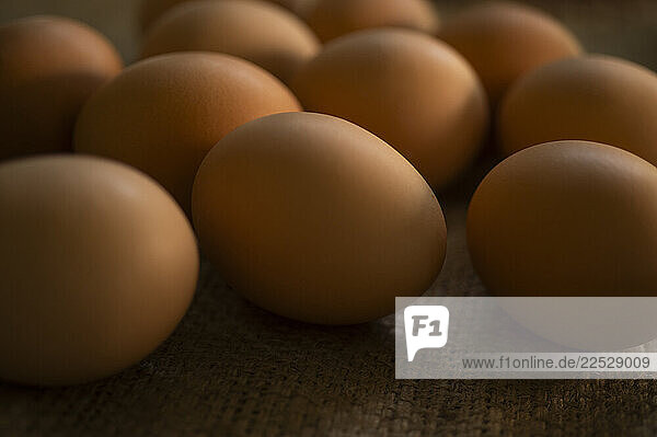 Studio shot of fresh brown eggs on burlap