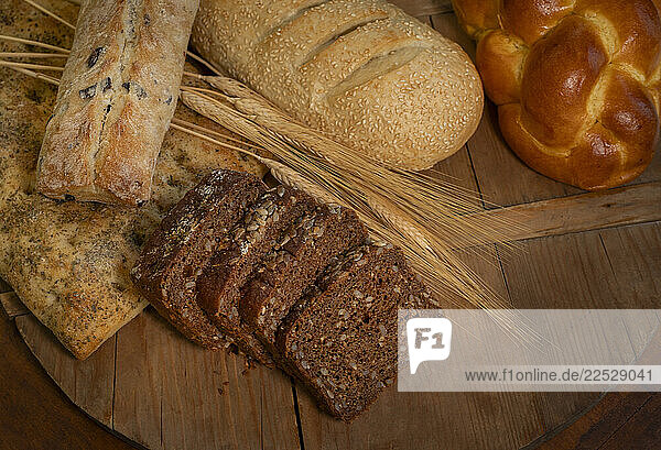 Overhead view of different breads on wooden cutting board