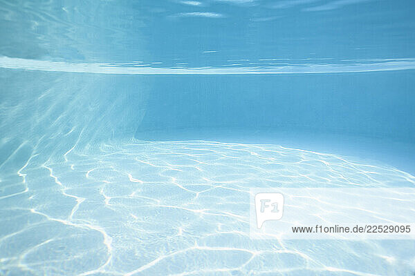 Turquoise water reflecting sunlight in swimming pool