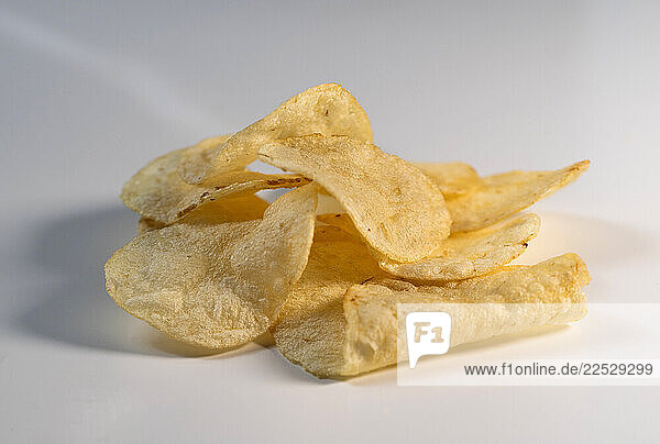 Studio shot of stack of potato chips on white background