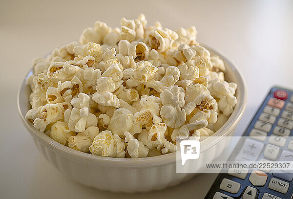 Bowl of popcorn and TV remote control