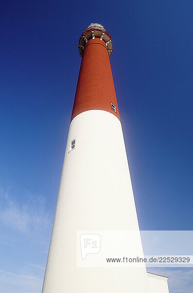 Low angle view of Old Barney Lighthouse against blue sky