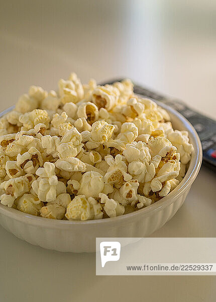 Bowl of popcorn and TV remote control