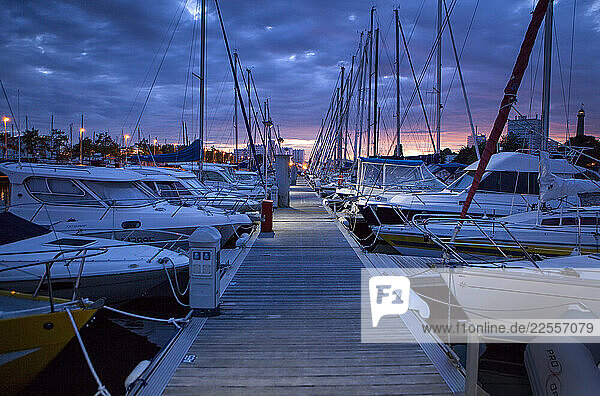 Cloudy sunset on a marina in Lorient. Lorient; Breton: An Oriant  is a commune and a seaport in the Morbihan department in Brittany in north-western France.