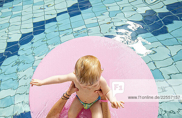 10 month old baby boy enjoying his first swim in a public swimming pool with his parents  Ploemeur  Brittany  France.
Gaspard Launay 
Mom: Éléonore Dad Christophe.