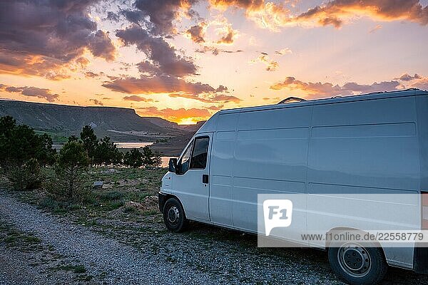 Camper van enjoying stunning sunset over Akko dam lake in Turkey