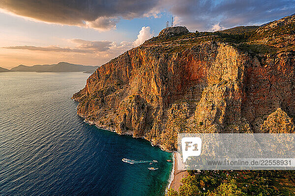 Butterfly Valley beach glowing at sunset in Fethiye