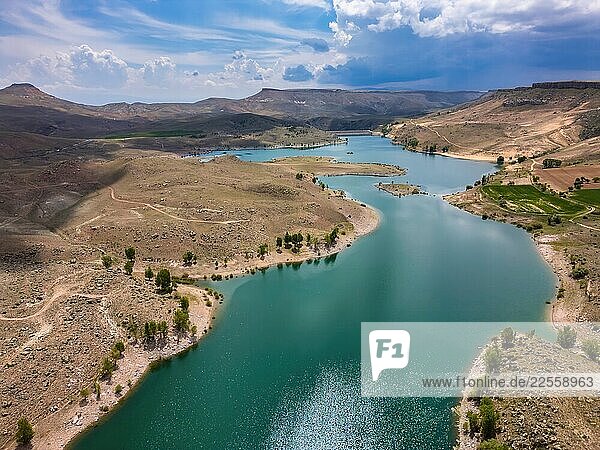 Drone aerial view of turquoise water in Akko dam lake in Turkey