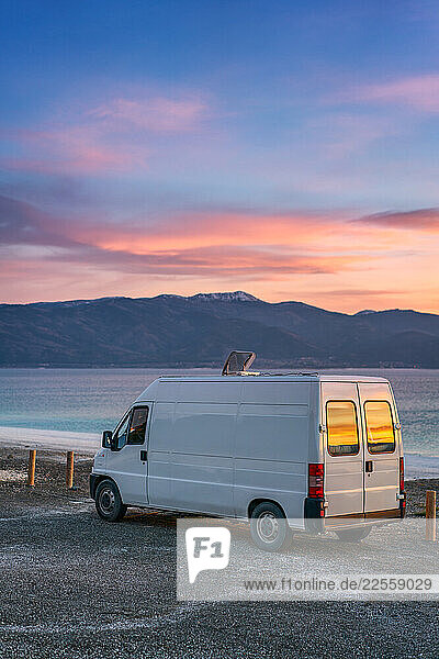 Camper van parked by Salda lake at sunset in Turkey