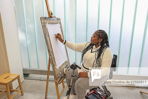 Disabled woman drawing at art classes