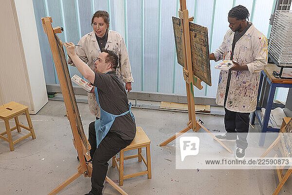 Disabled people painting at workshop