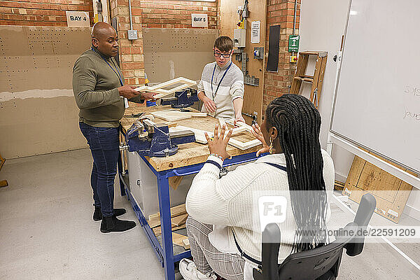 Disabled men and woman working in workshop