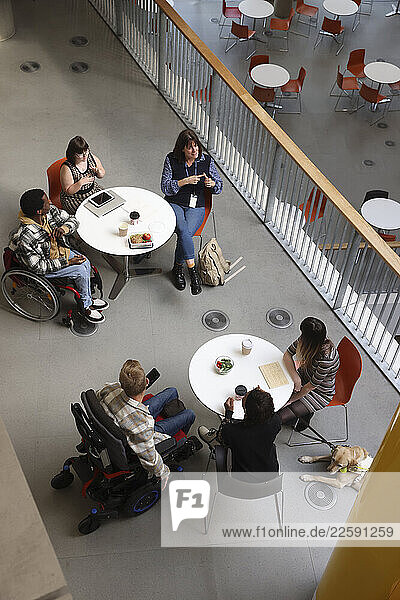 Disabled people talking at tables